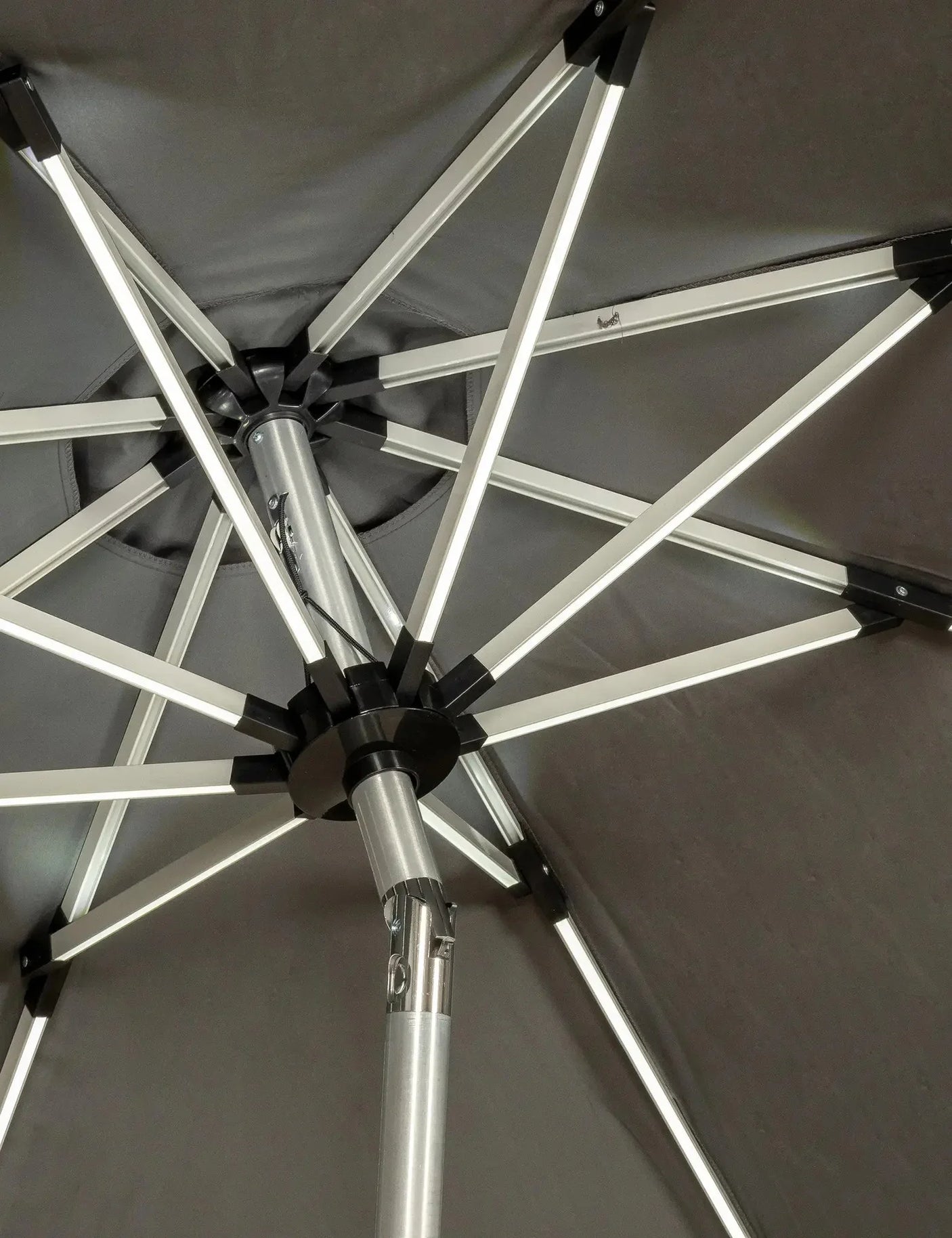 Close view of metal frame and support ribs on a grey garden parasol