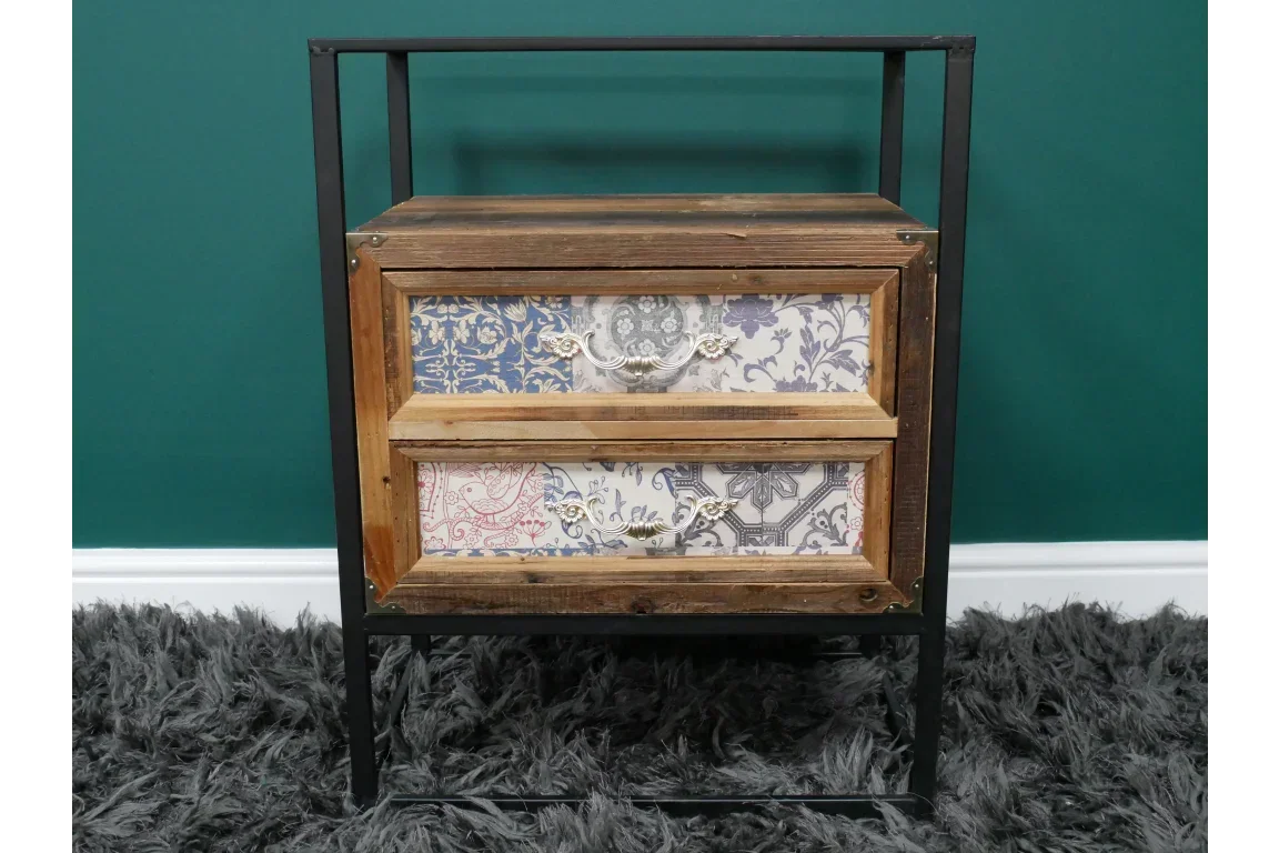 Rustic wooden bedside table with patterned drawers and metal frame on grey rug