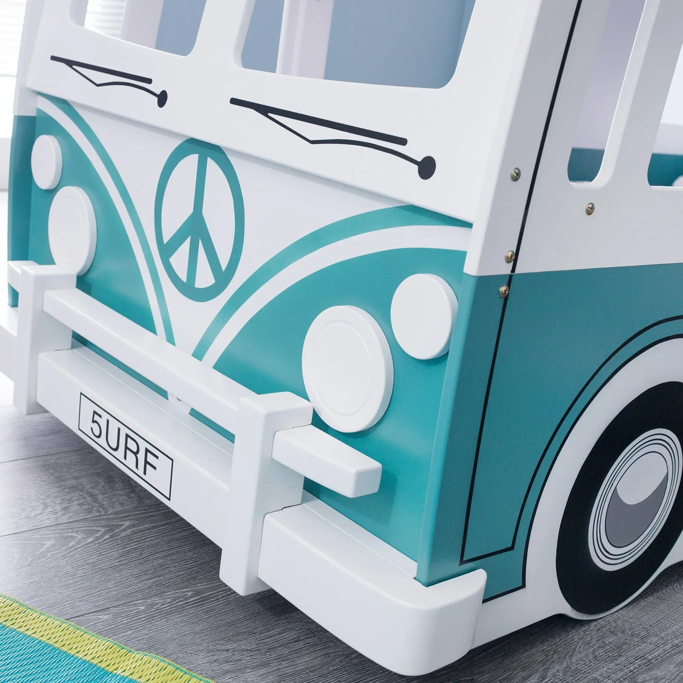 Front detail of teal and white kids camper van bed with wheel print and license plate design
