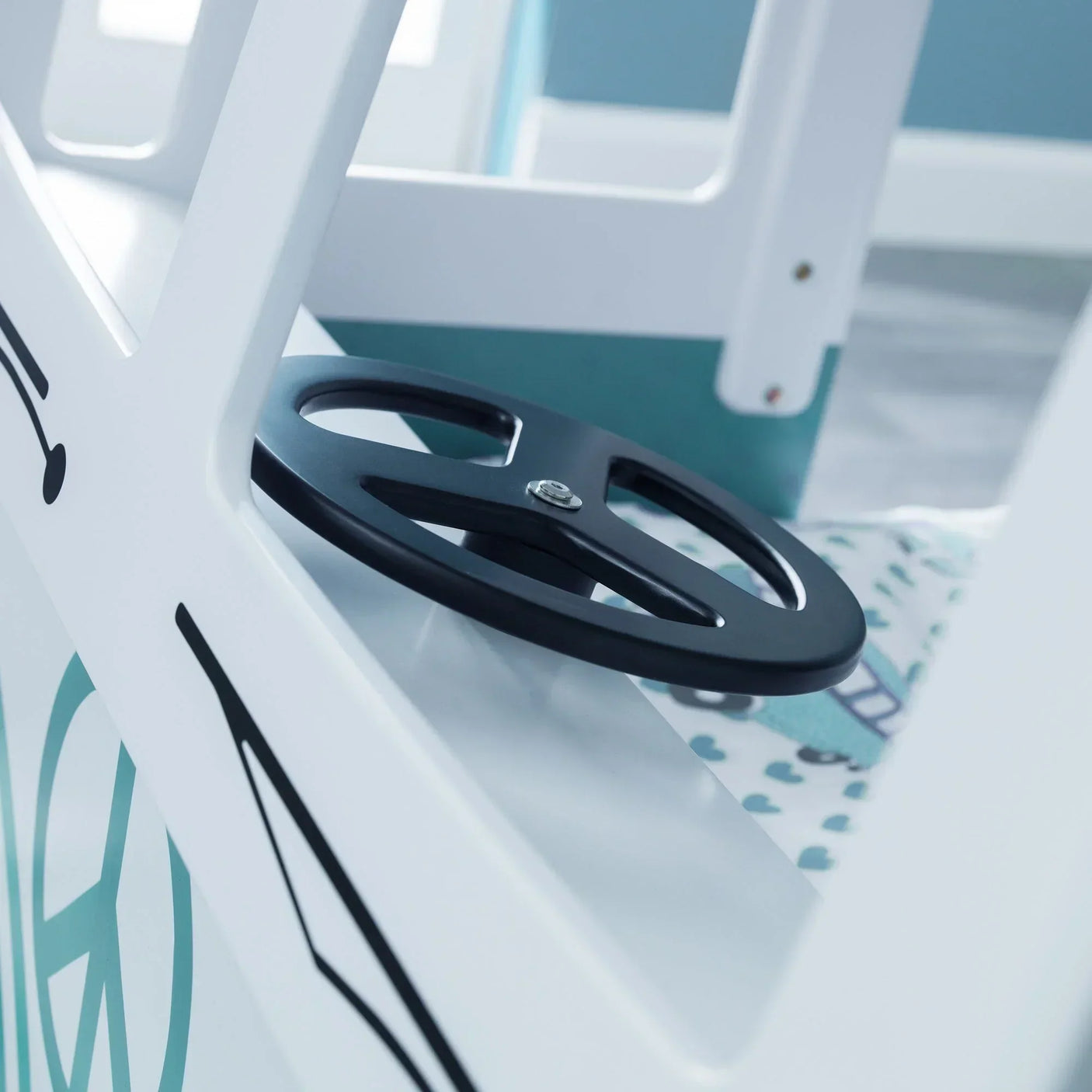 Children’s novelty bed with black steering wheel detail and white frame