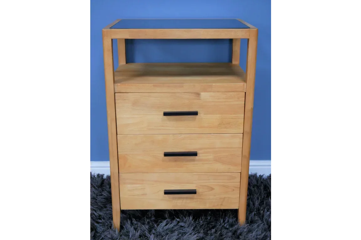 Light wood chest of drawers with three drawers, black handles and open shelf, front view