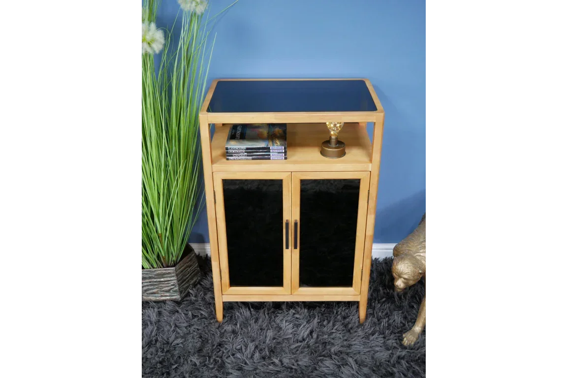 Wood and black glass cabinet with two doors, open shelf and decorative items on top