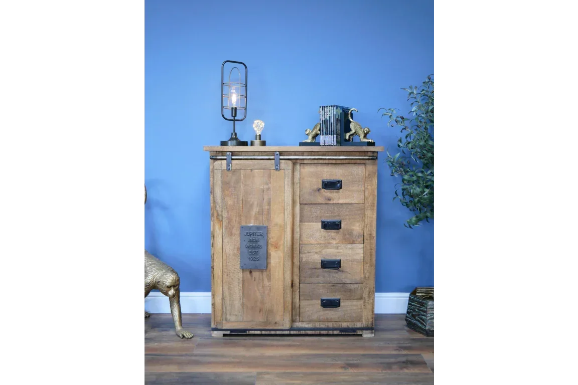 Rustic wooden sideboard with black metal handles and sliding barn door against blue wall