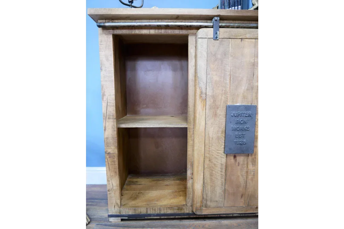 Rustic wooden storage cabinet with open shelving and sliding door featuring metal plaque