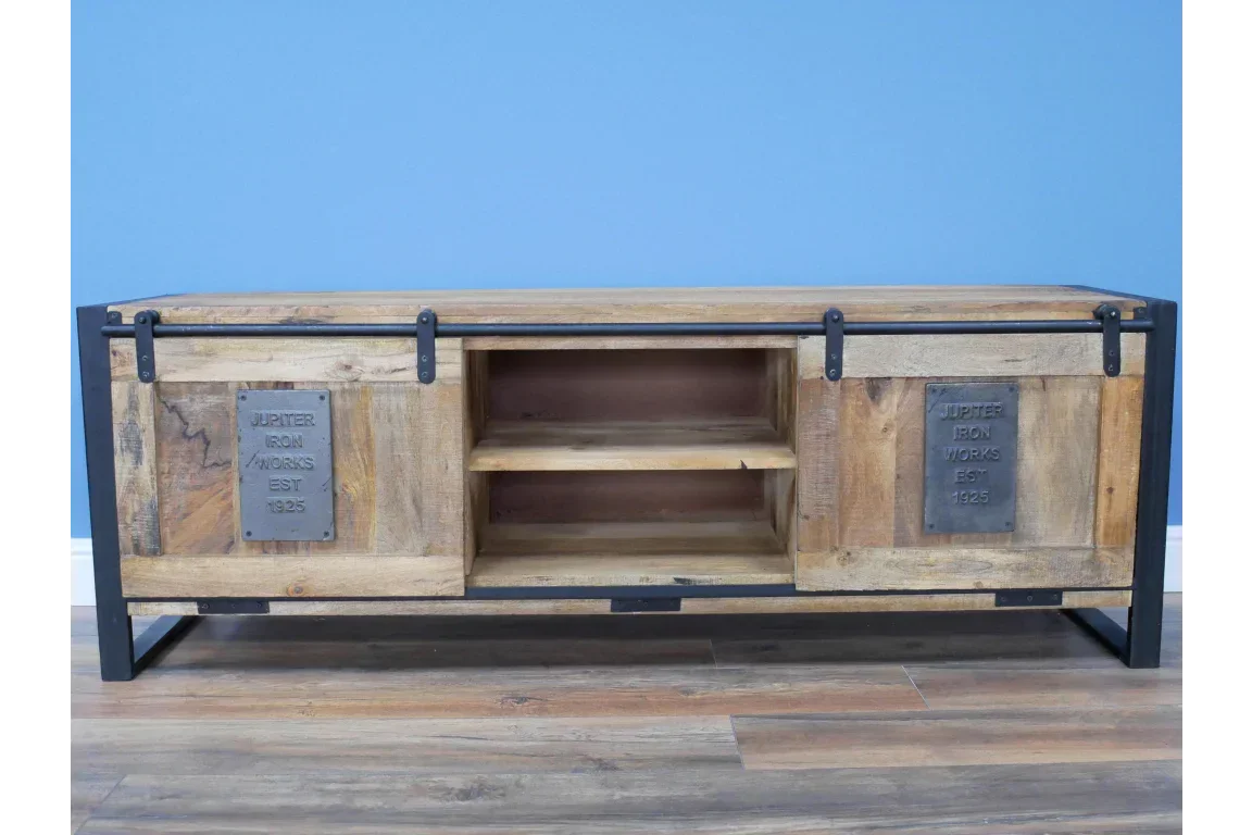Industrial wooden TV unit with sliding doors, metal frame, and open shelving on hardwood floor
