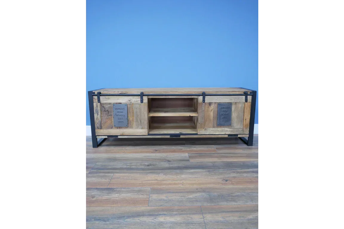 Rustic wood and metal TV unit with sliding doors and central shelves on wooden floor