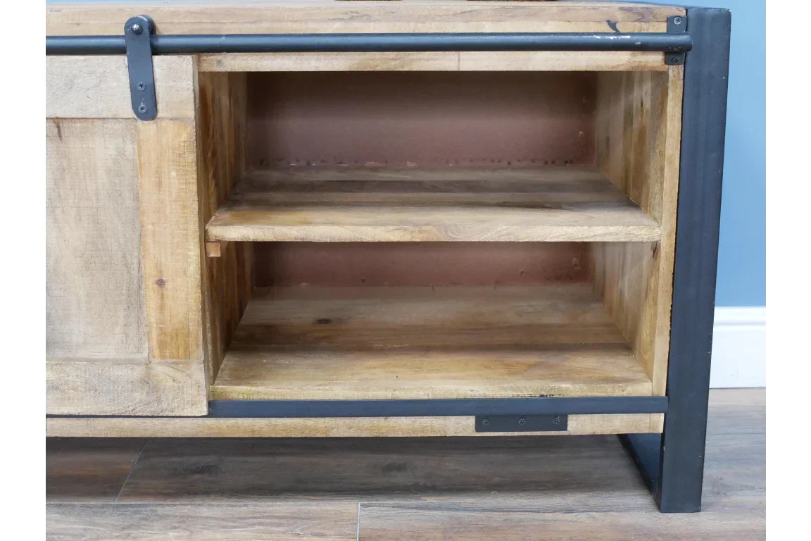 Wooden sideboard with open shelving and black metal frame against blue wall