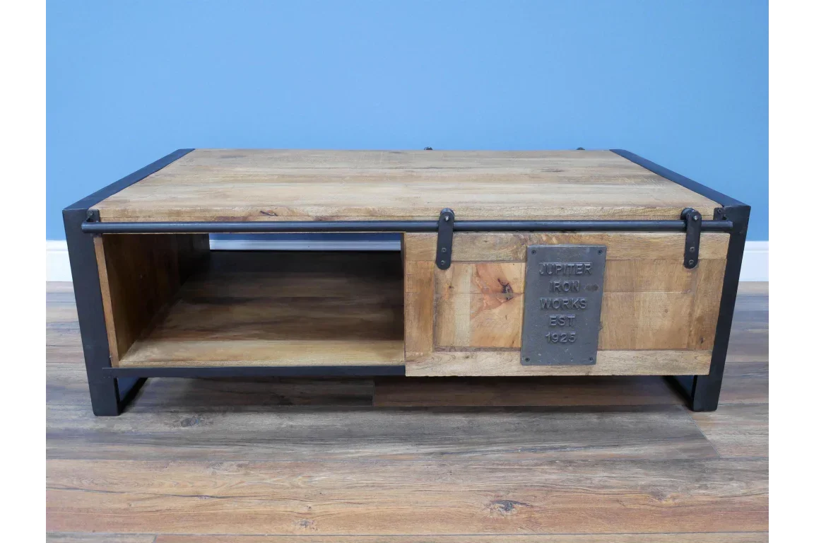 Industrial coffee table with sliding wooden door, open shelf and black metal frame