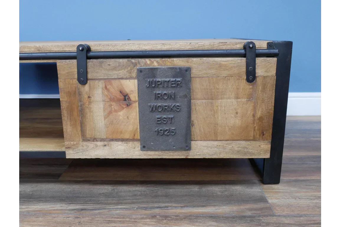 Industrial style wood coffee table with black metal frame and plaque detail on front