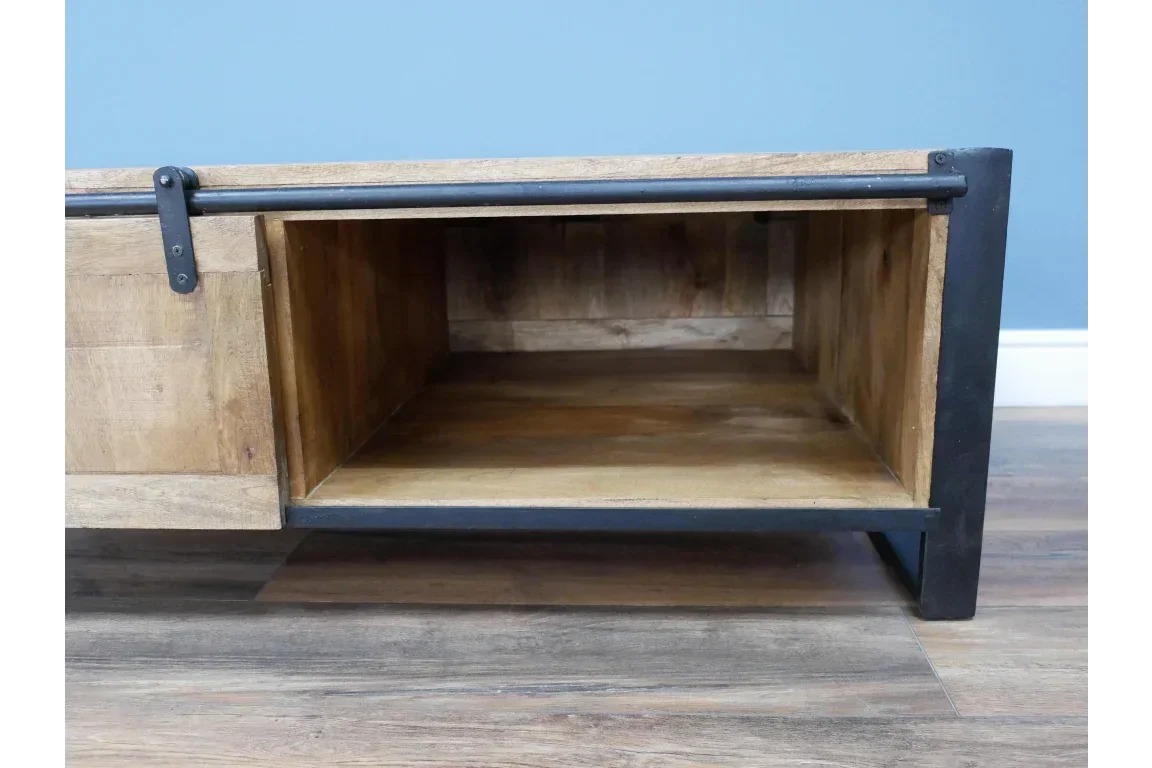 Open storage shelf in industrial wood and metal TV unit on wooden floor