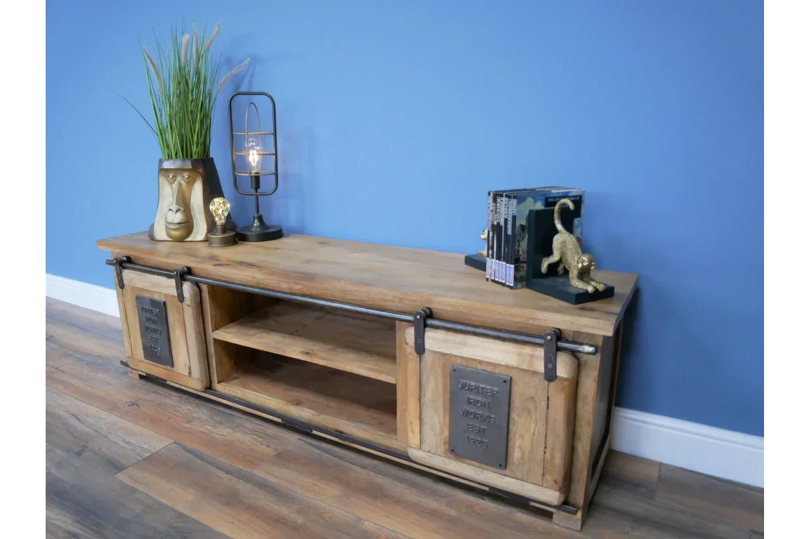 Industrial wood TV unit with sliding doors, open shelf, and decorative home accessories