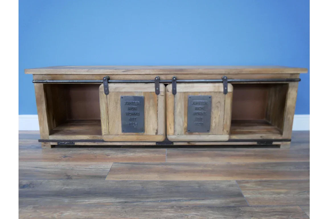Industrial wood TV unit with sliding metal doors and open shelves against blue wall