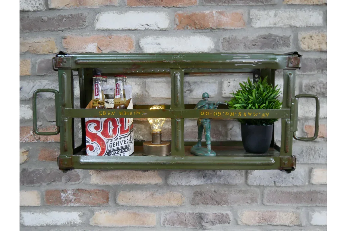 Green metal wall shelf with beer bottles, potted plant, lamp and toy soldiers on brick wall