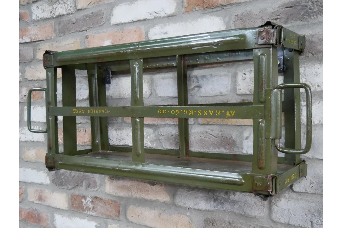 Green metal industrial wall shelf with handles mounted on brick wall