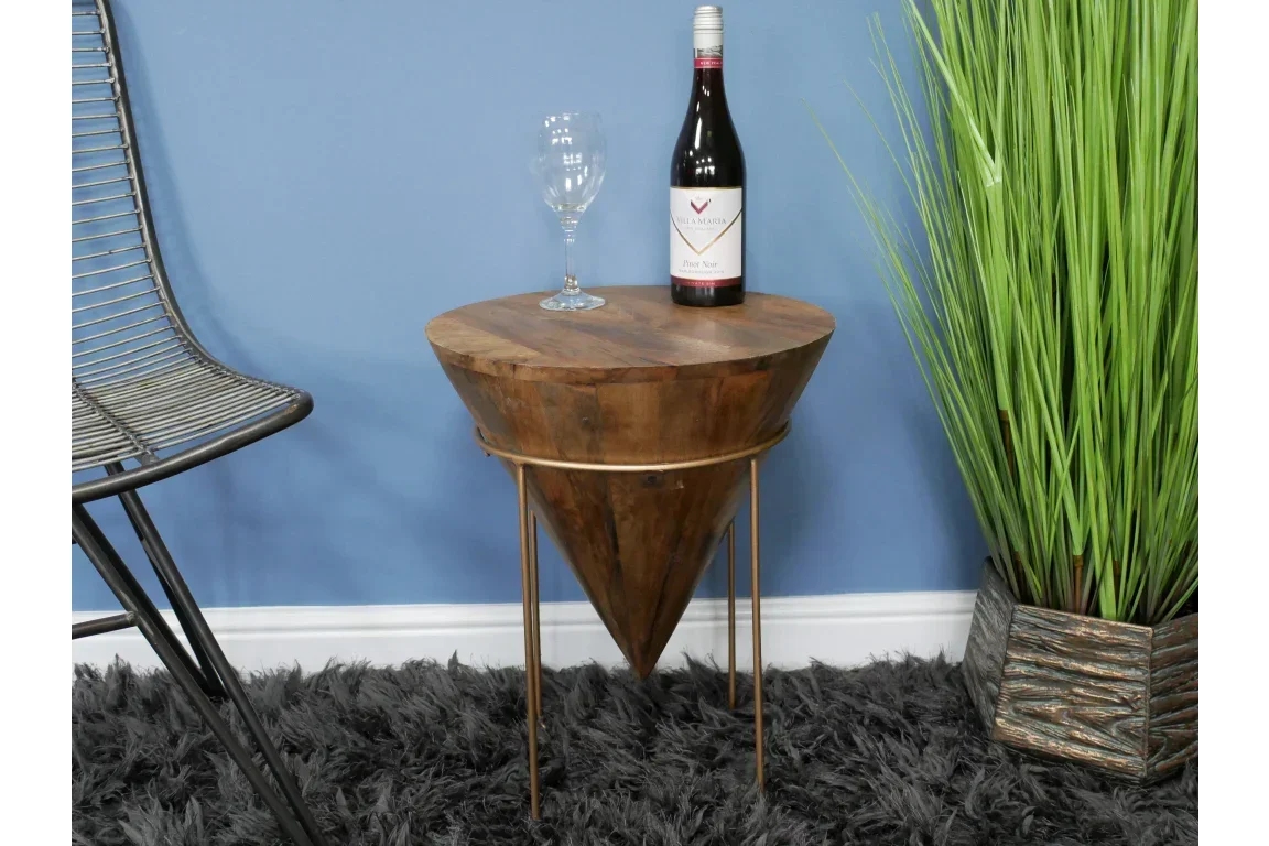 Modern wooden side table with conical base and gold metal legs on a shaggy rug