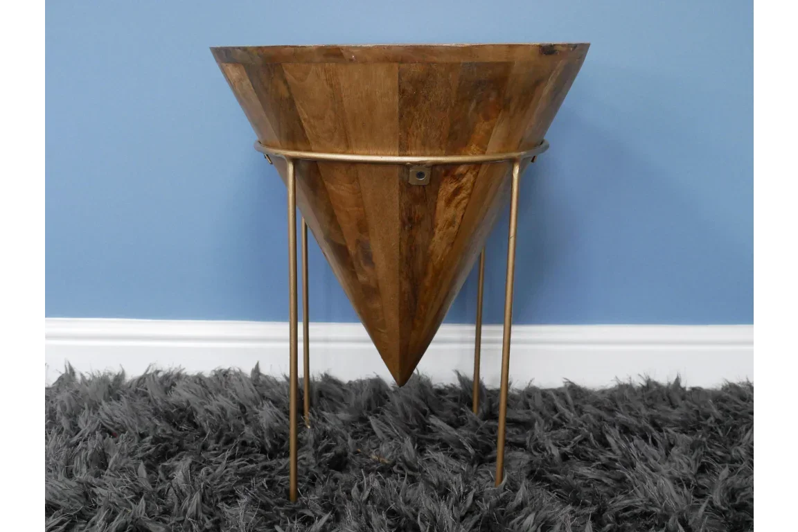 Wooden planter with tapered cone design and gold metal stand on grey rug