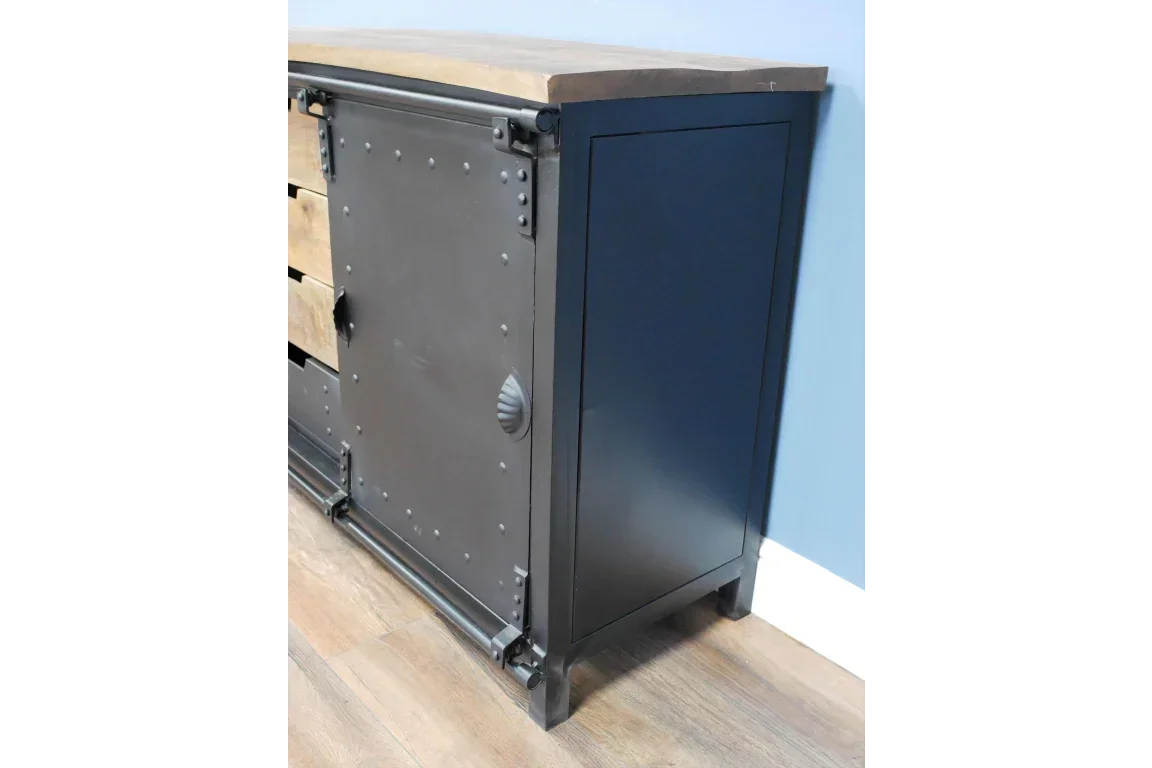 Industrial sideboard with black metal sliding door and light wood top on laminate floor