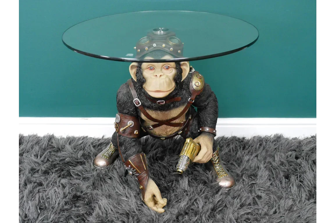 Steampunk monkey side table with round glass top on grey rug