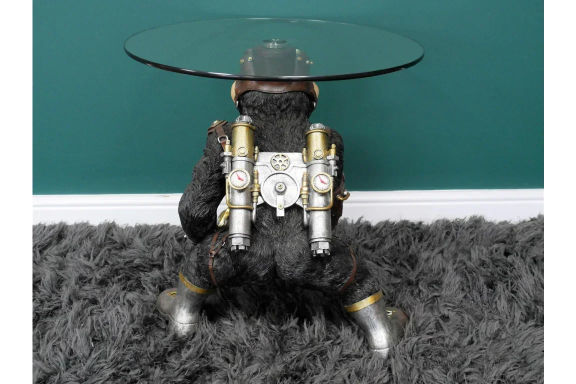 Steampunk monkey side table with glass top and metallic jetpack design on plush carpet