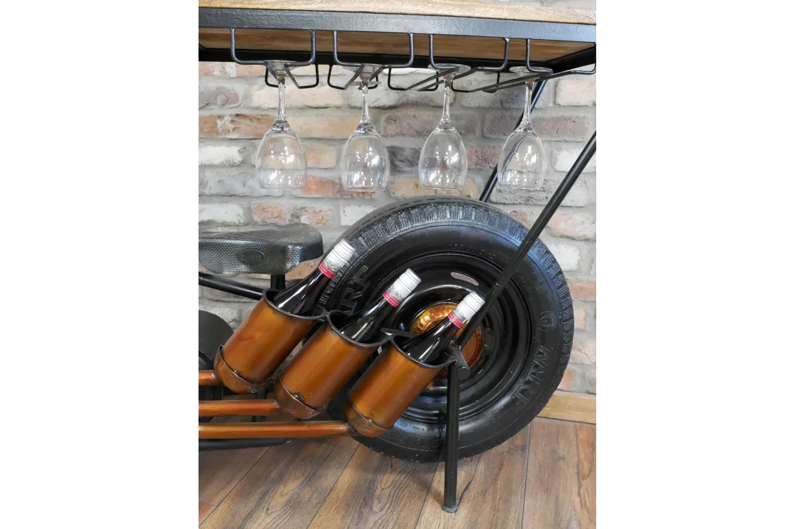 Industrial style bar cart with metal wine bottle holders, hanging wine glasses, and tire detail