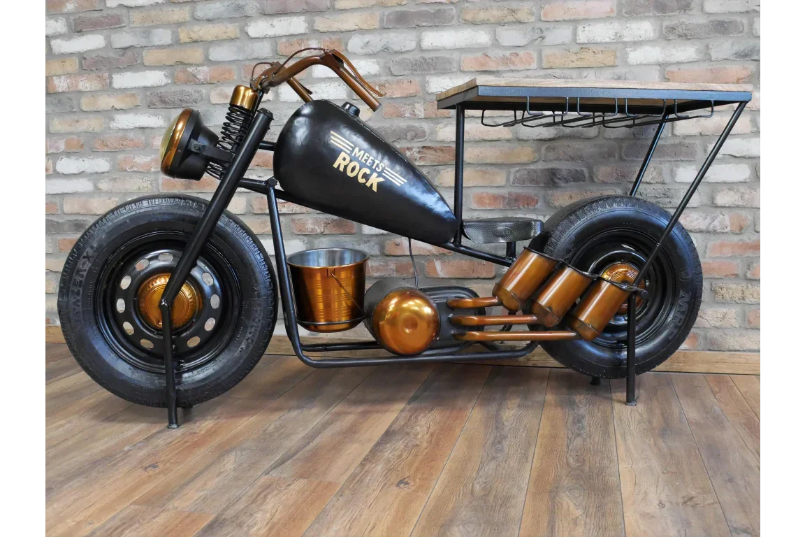 Industrial motorcycle bar table with metal and wood top, black and bronze finish, against brick wall
