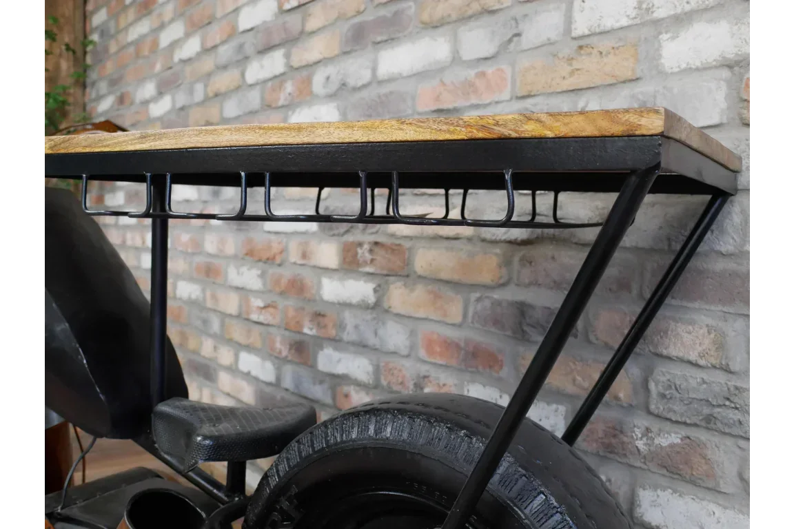 Industrial bar table with wooden top and metal frame against brick wall