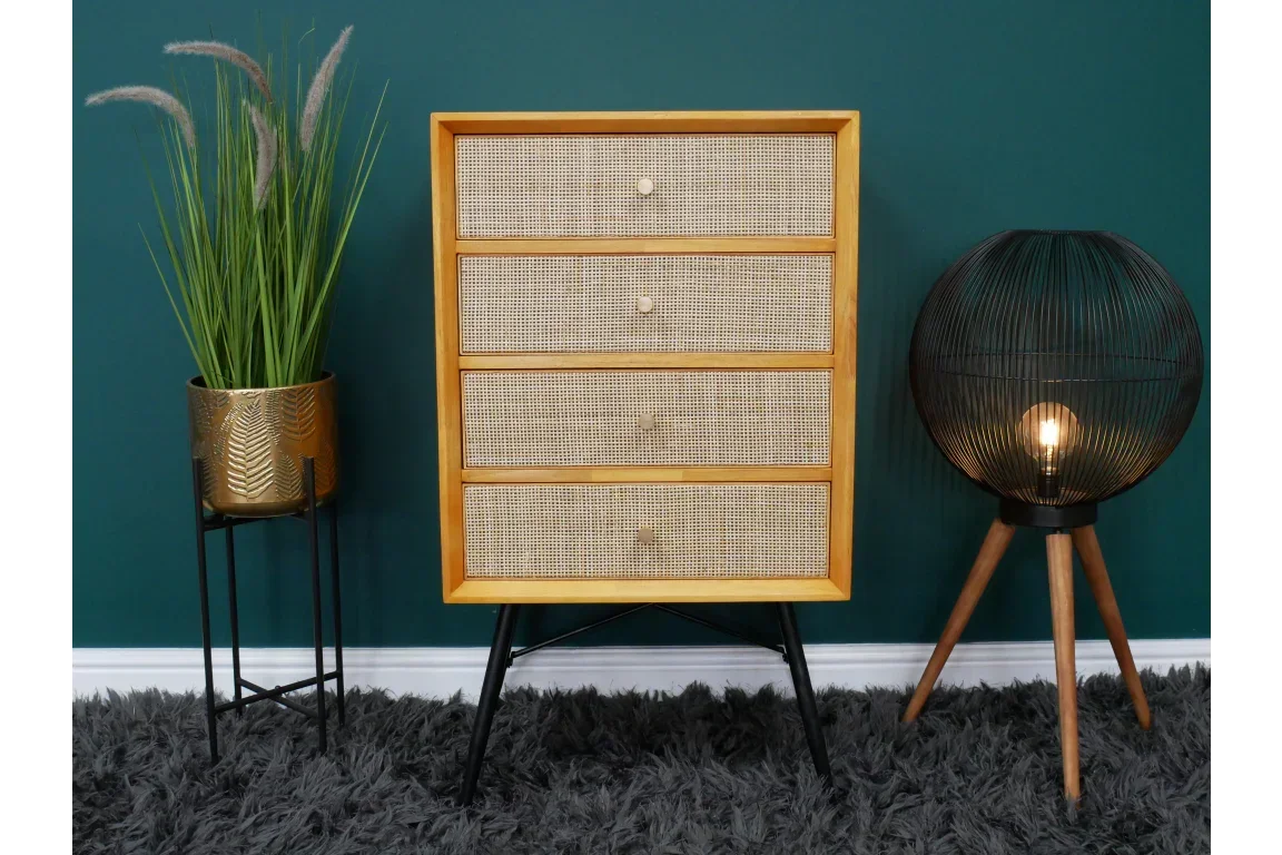 Rattan chest of drawers with black legs styled with plant and tripod floor lamp