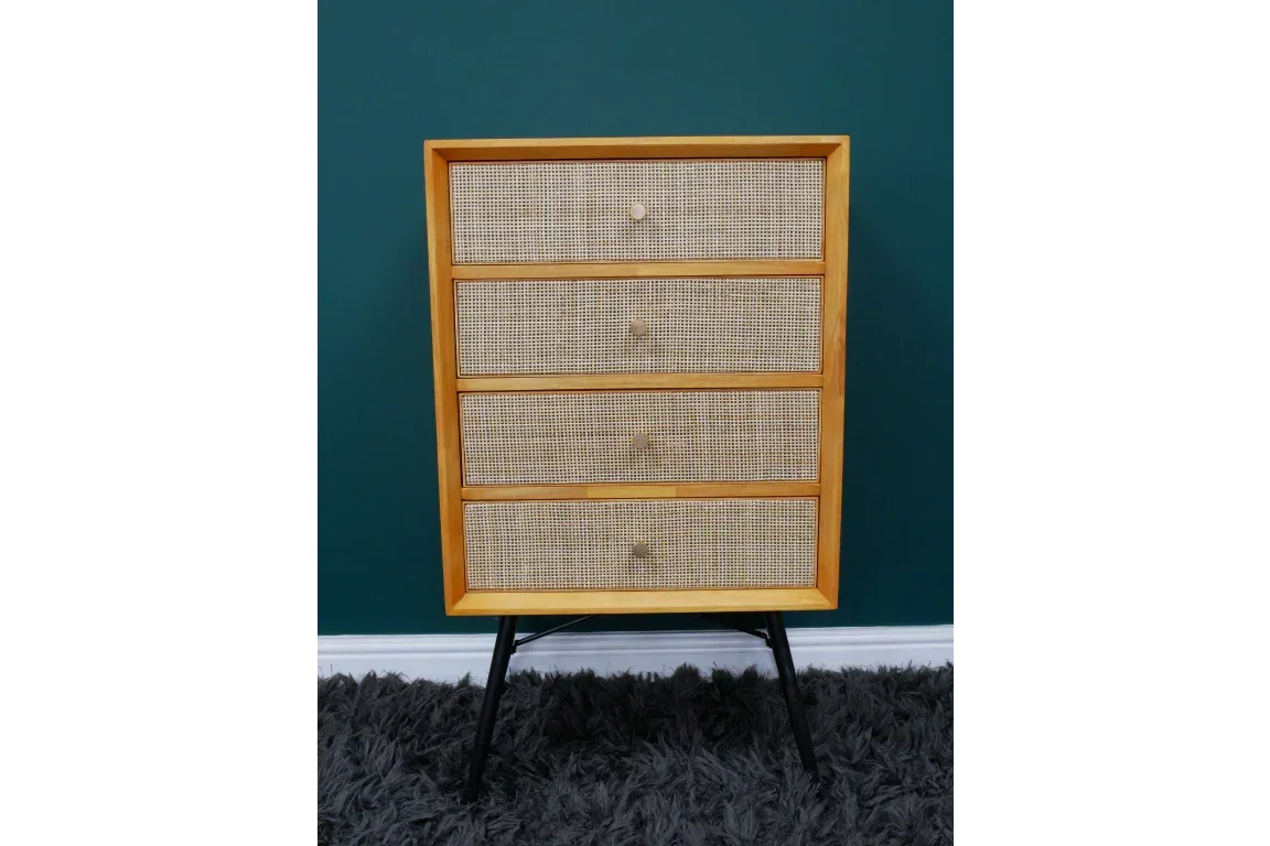 wooden chest of drawers with rattan fronts and black legs on grey rug