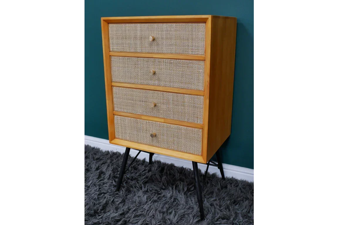 Wooden chest of drawers with cane fronts and black legs in modern interior