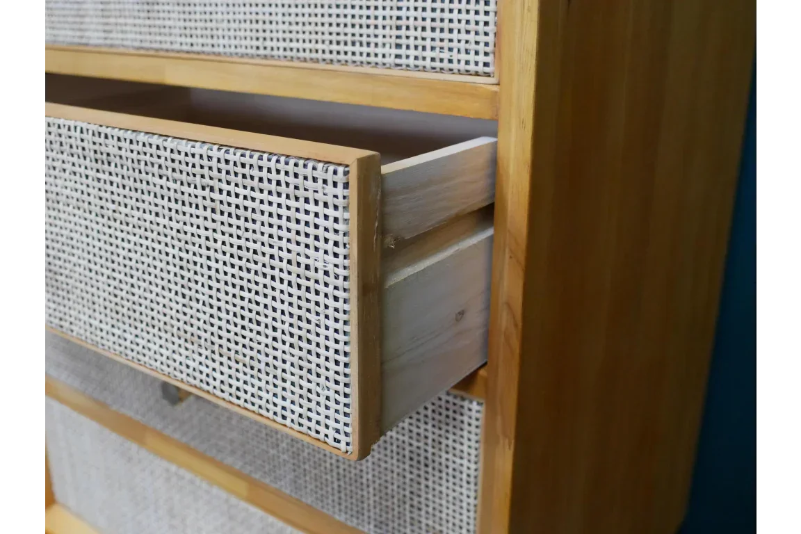 Rattan drawer detail on wooden chest of drawers with open storage compartment