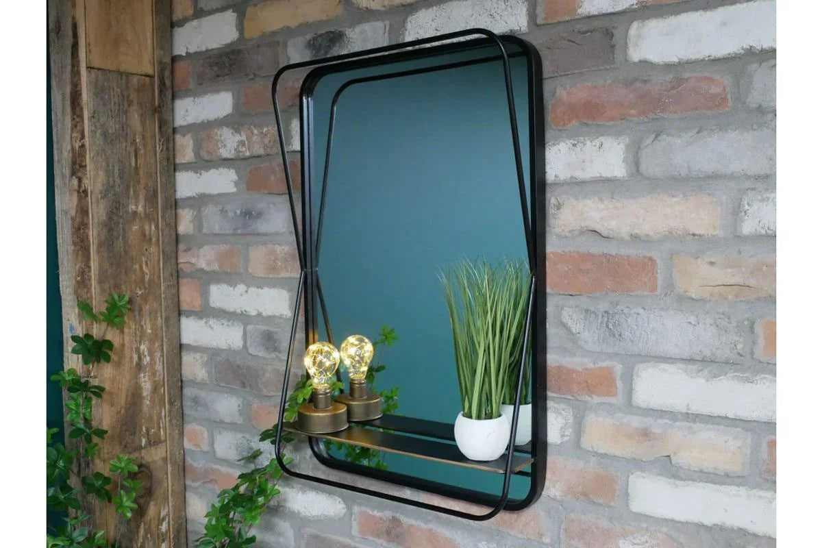 Rectangular black metal wall mirror with shelf, decorative bulbs, and plant in white pot