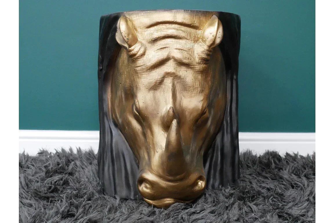 Gold horse head side table with textured finish on dark faux fur rug