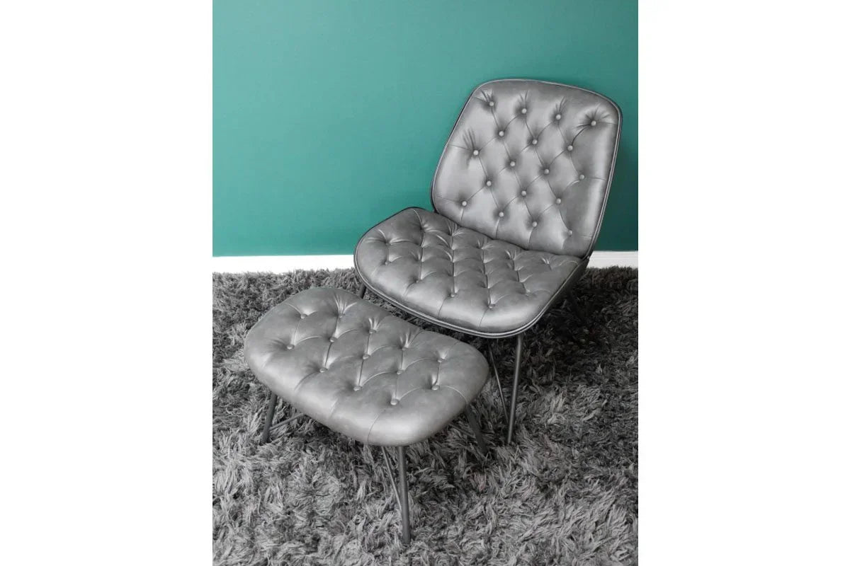 Grey faux leather accent chair with matching footstool on shaggy rug