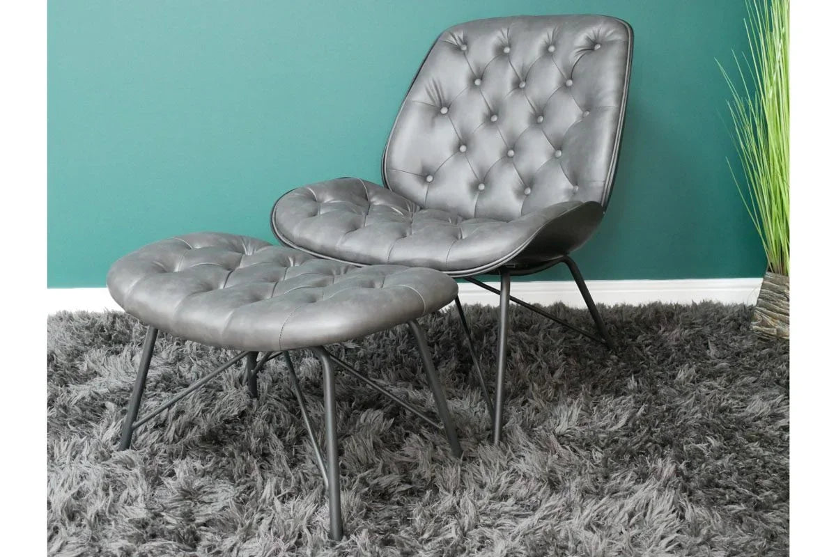 Grey tufted accent chair with matching ottoman on plush rug