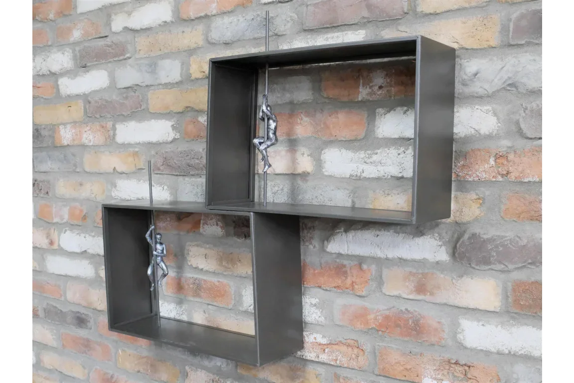Industrial wall shelf with metal box frames and silver climbing figures on brick wall