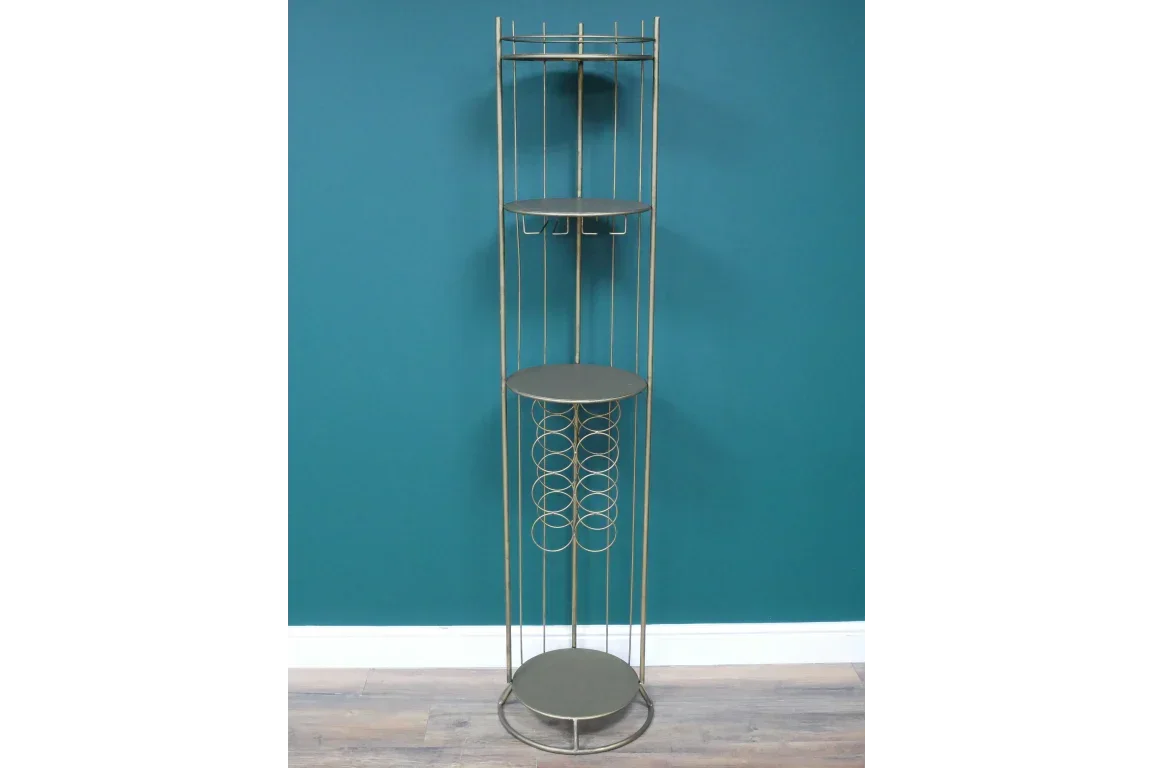 Tall gold metal wine rack with circular shelves and vertical bottle storage against teal wall