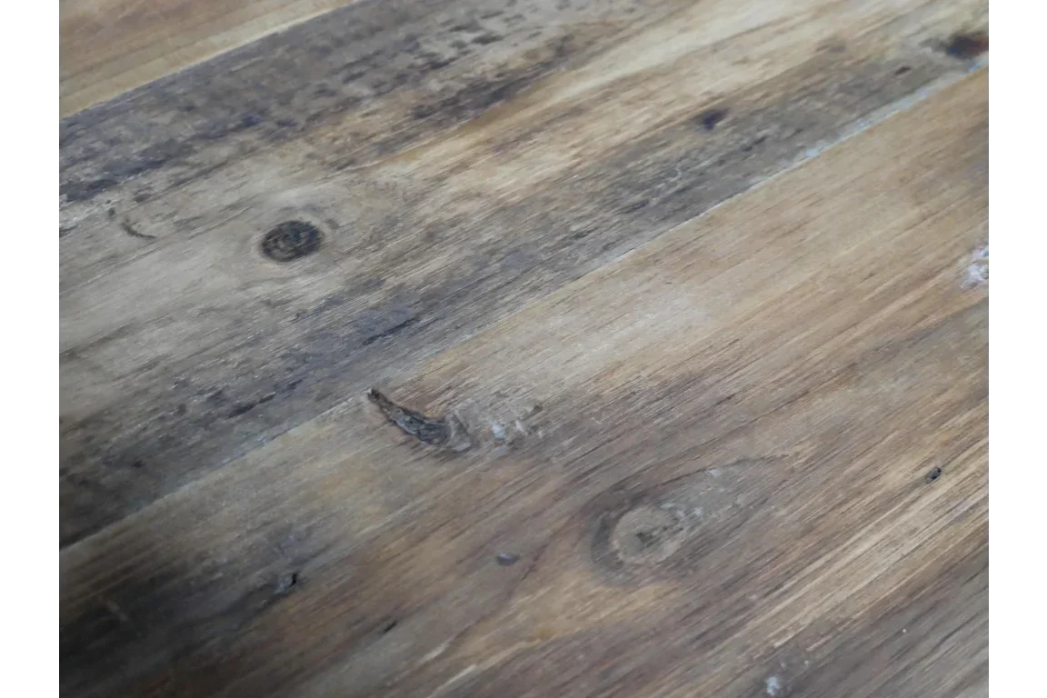 close-up of rustic wood dining table surface with visible grain and natural knots