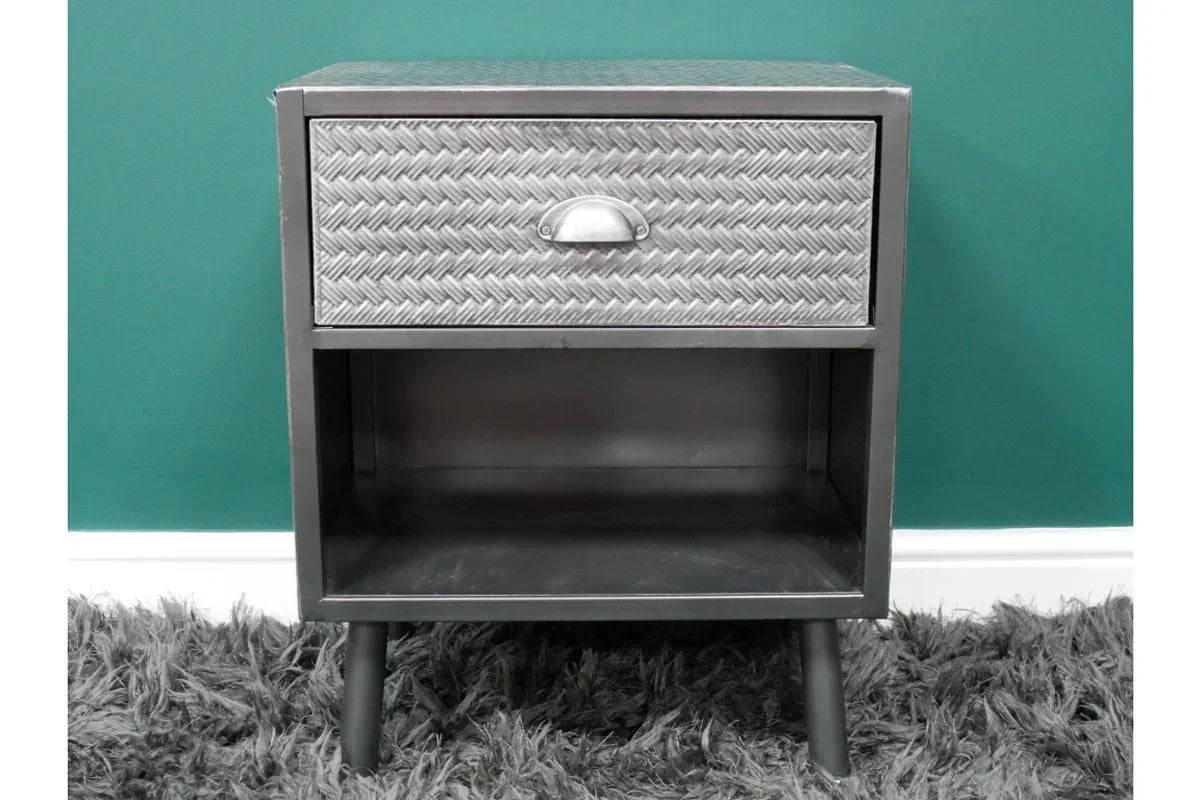 Metal bedside table with textured drawer and open storage compartment on short legs