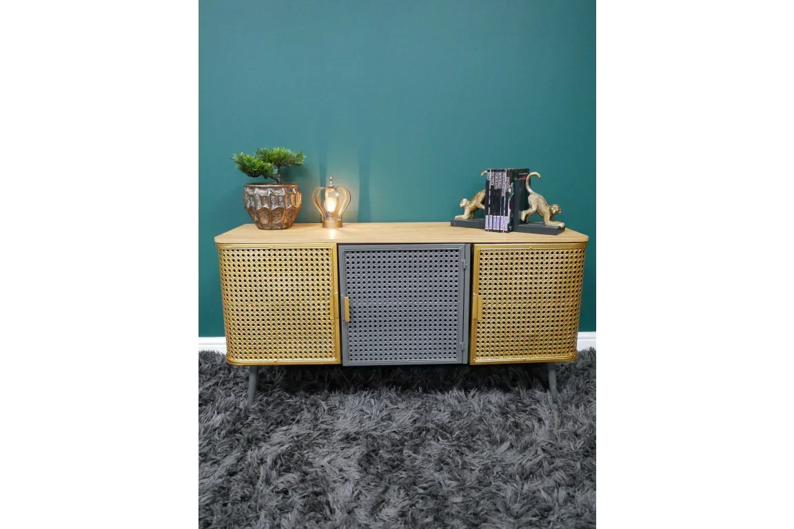Rattan sideboard cabinet with black central door, decorative ornaments and books on top