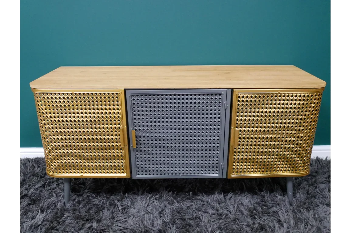 Wooden sideboard with rattan doors and grey metal centre on grey rug against teal wall