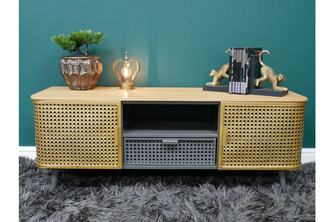 Rattan TV unit with cane doors, black central drawer, and decorative accessories on top