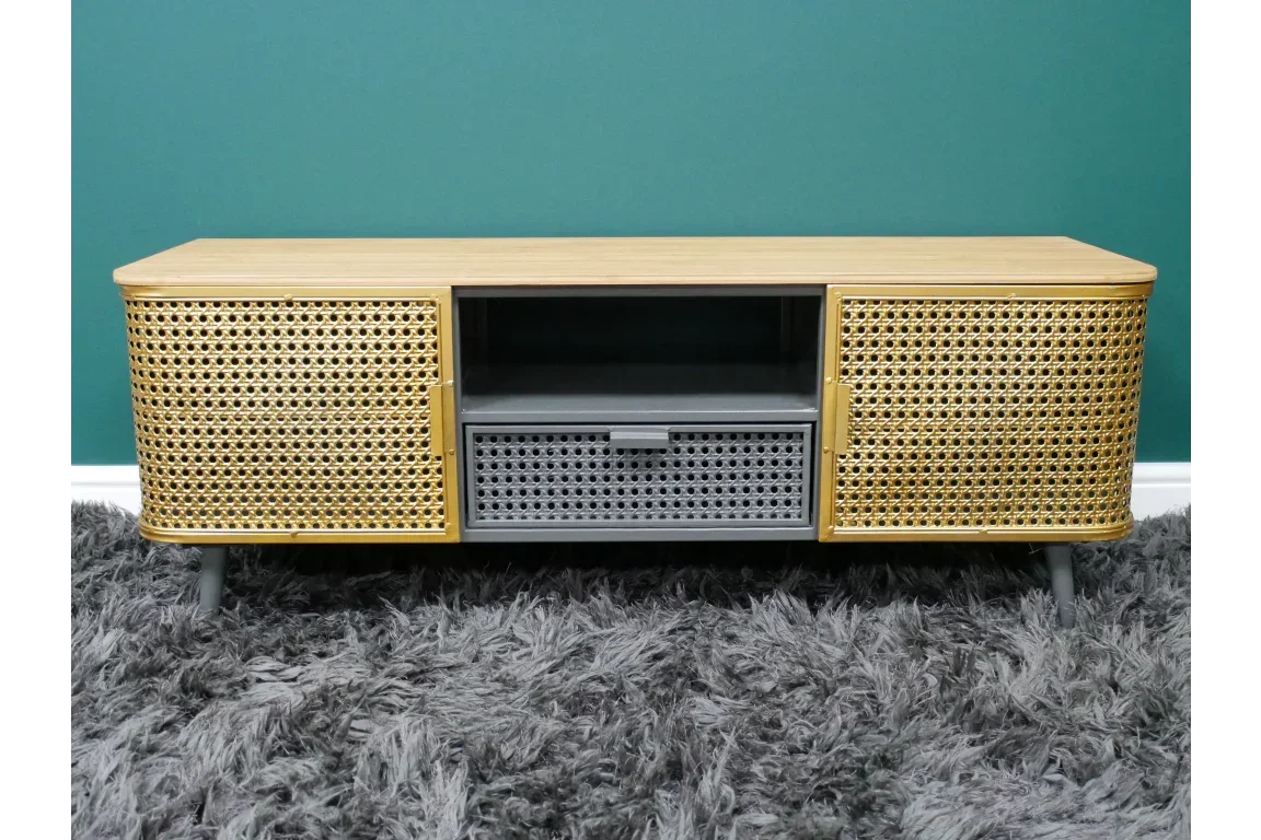 Rattan tv unit with storage drawers and open shelf on grey rug against green wall
