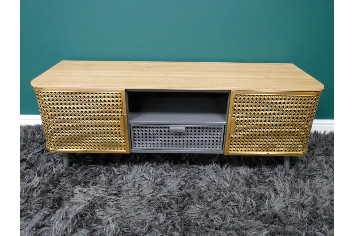 Rattan TV unit with two woven cane doors, open shelf and central drawer on grey legs