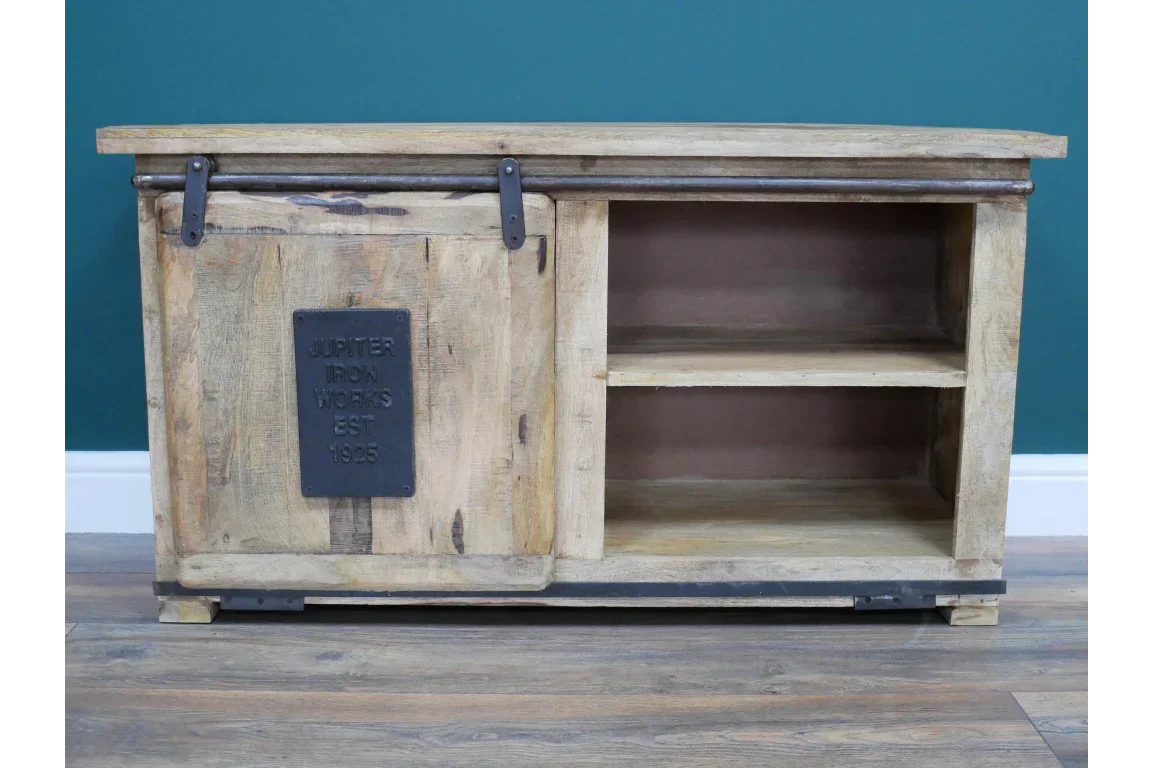 Rustic wood TV unit with sliding barn door, open shelving, and metal accent plaque