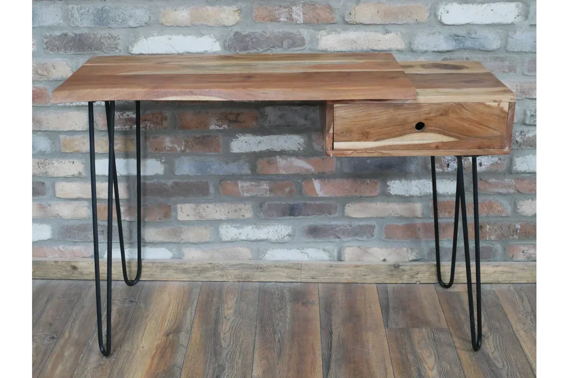 Wooden desk with metal hairpin legs and single drawer, set against a brick wall