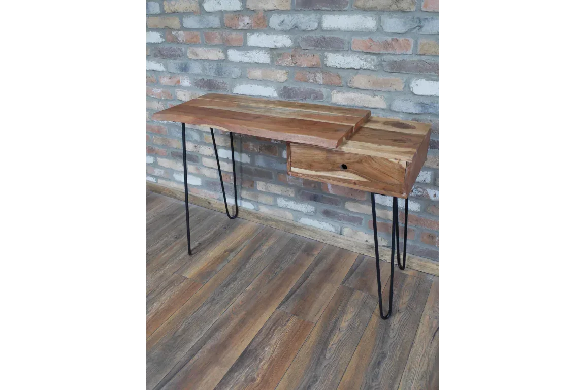 Wood console table with metal hairpin legs and single drawer against brick wall