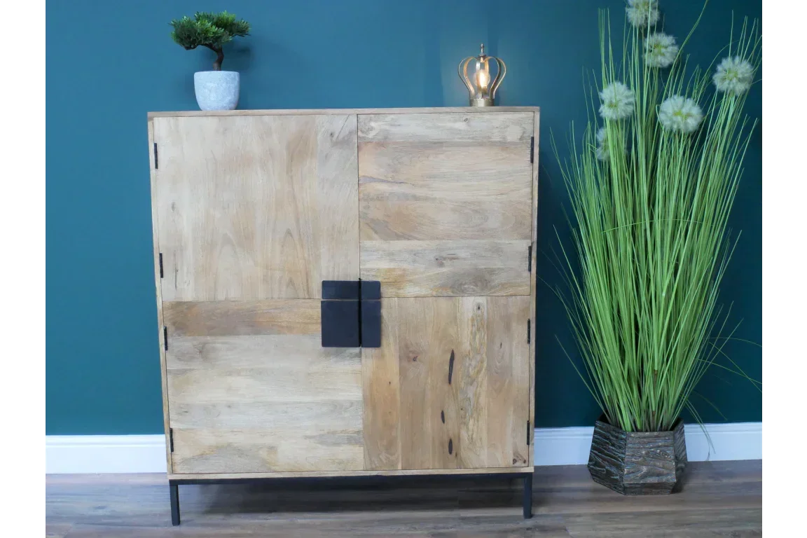 Natural wood cabinet with black metal legs and handles against teal wall, modern decor