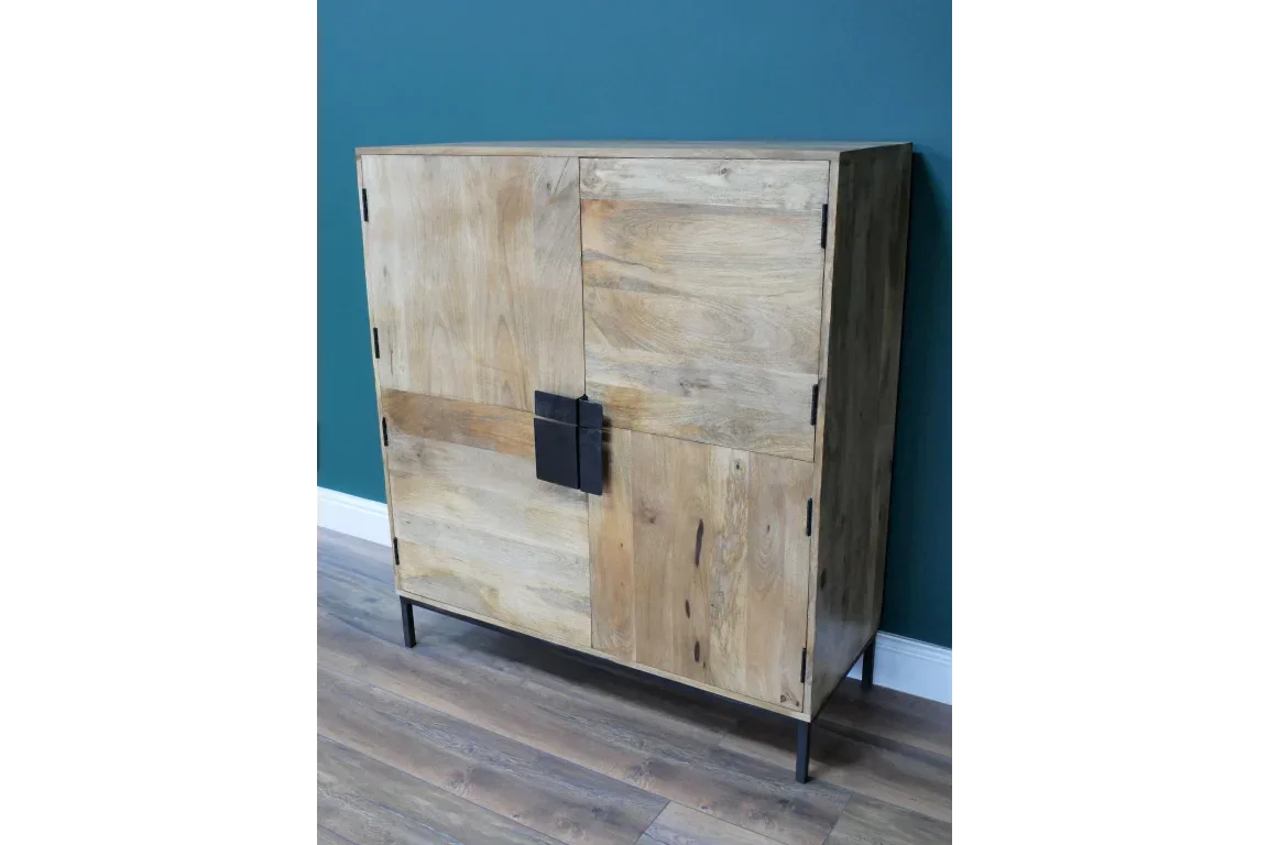 Solid wood sideboard with black metal legs and modern square handles against teal wall