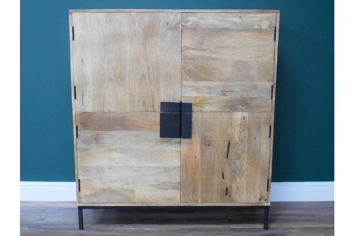 Natural wood sideboard cabinet with black metal handles and legs against blue wall