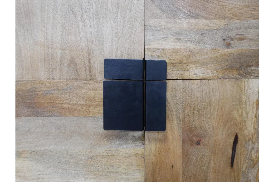 Square black metal handle on natural wood furniture with visible grain pattern